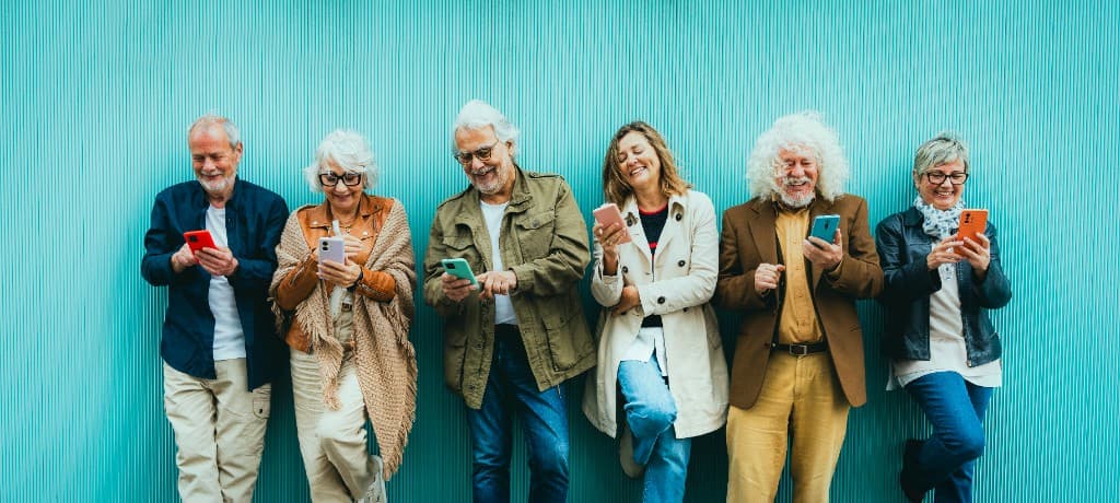 Seniors using phones outdoors